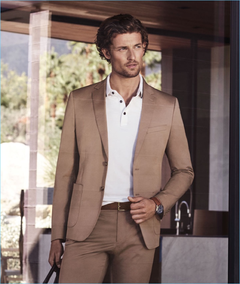 A sleek vision, Wouter Peelen dons a brown suit for Michael Kors' spring-summer 2017 campaign.