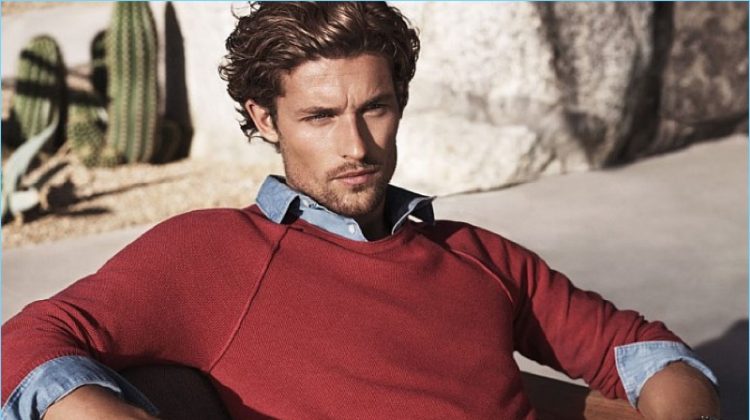 Lounging in a red sweater and navy chinos, Wouter Peelen fronts Michael Kors' spring-summer 2017 campaign.