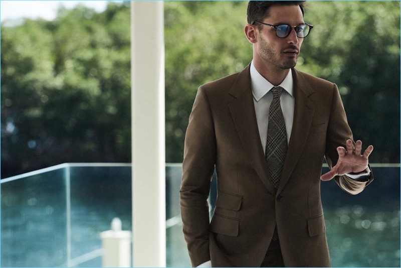 Tap into an earthy color palette with Mr Porter’s Kingsman brown suit jacket $1,395 and trousers $495. Complement the smart look with a Kingsman + Turnbull & Asser oxford shirt $350, Kingsman + Cutler & Gross D-Frame optical glasses $450, and a Kingsman + Drake’s checked wool, silk, and linen-blend tie $145.