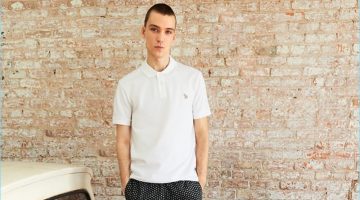 Front and center, Marc Lüloh rocks a regular fit polo, black dot shorts, and sneakers from PS by Paul Smith.