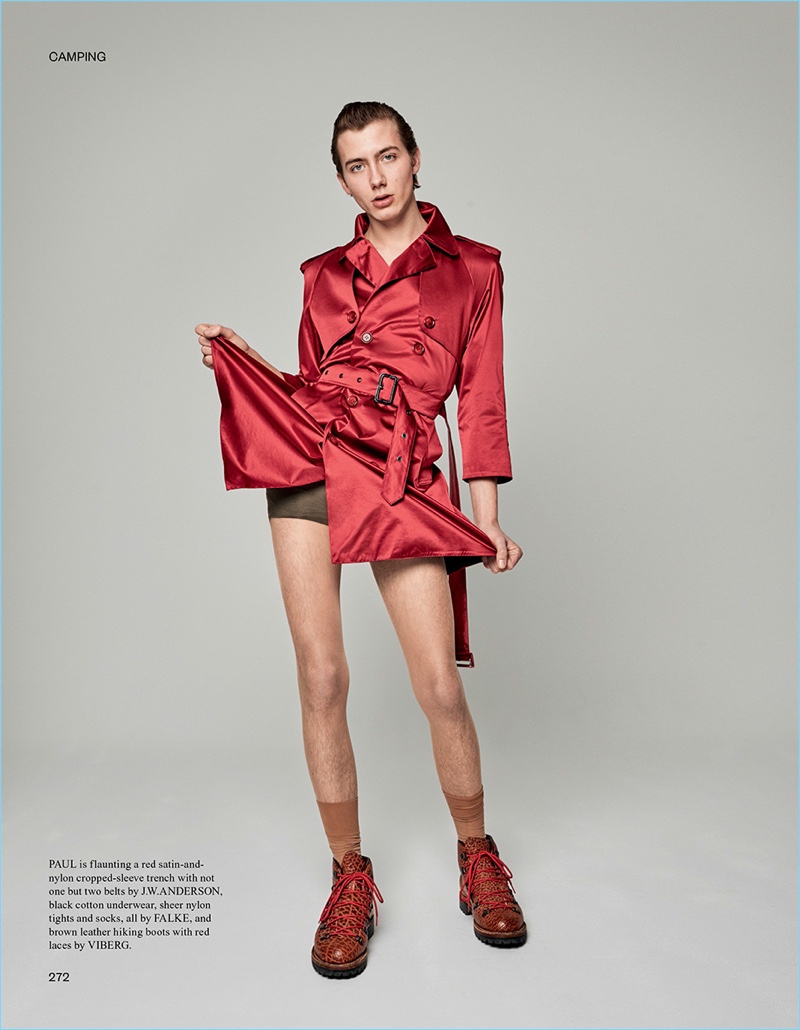 Making a flirty pose, Paul Hameline dons a red satin trench by J.W. Anderson with Viberg hiking boots.