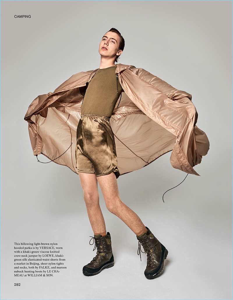 Model Paul Hameline sports a Versace hooded parka with a Loewe sweater and Le Chameau hunting boots.