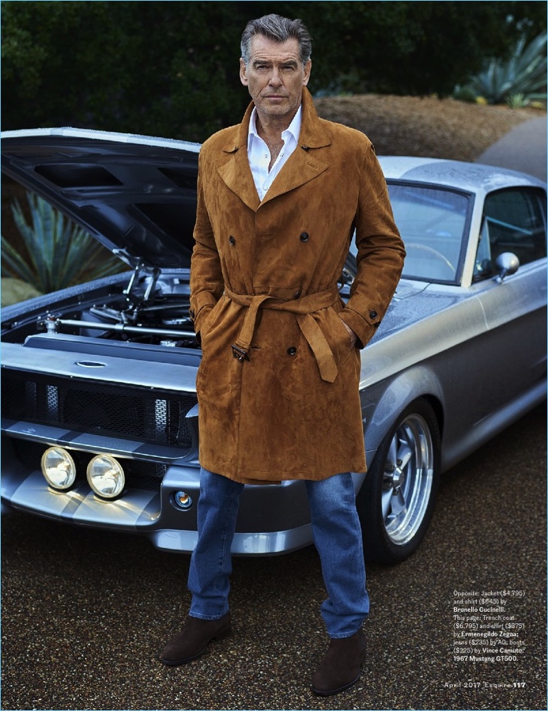 Pierce Brosnan dons a shirt and suede trench coat by Ermenegildo Zegna with AG jeans, and Vince Camuto boots.