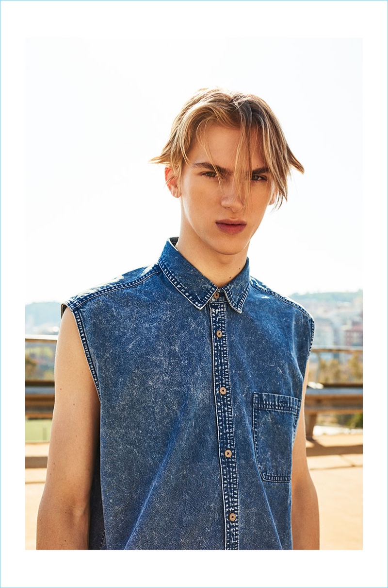 Modeling a sleeveless denim shirt, Dominik Sadoch stars in the summer 2017 campaign of Reserved.