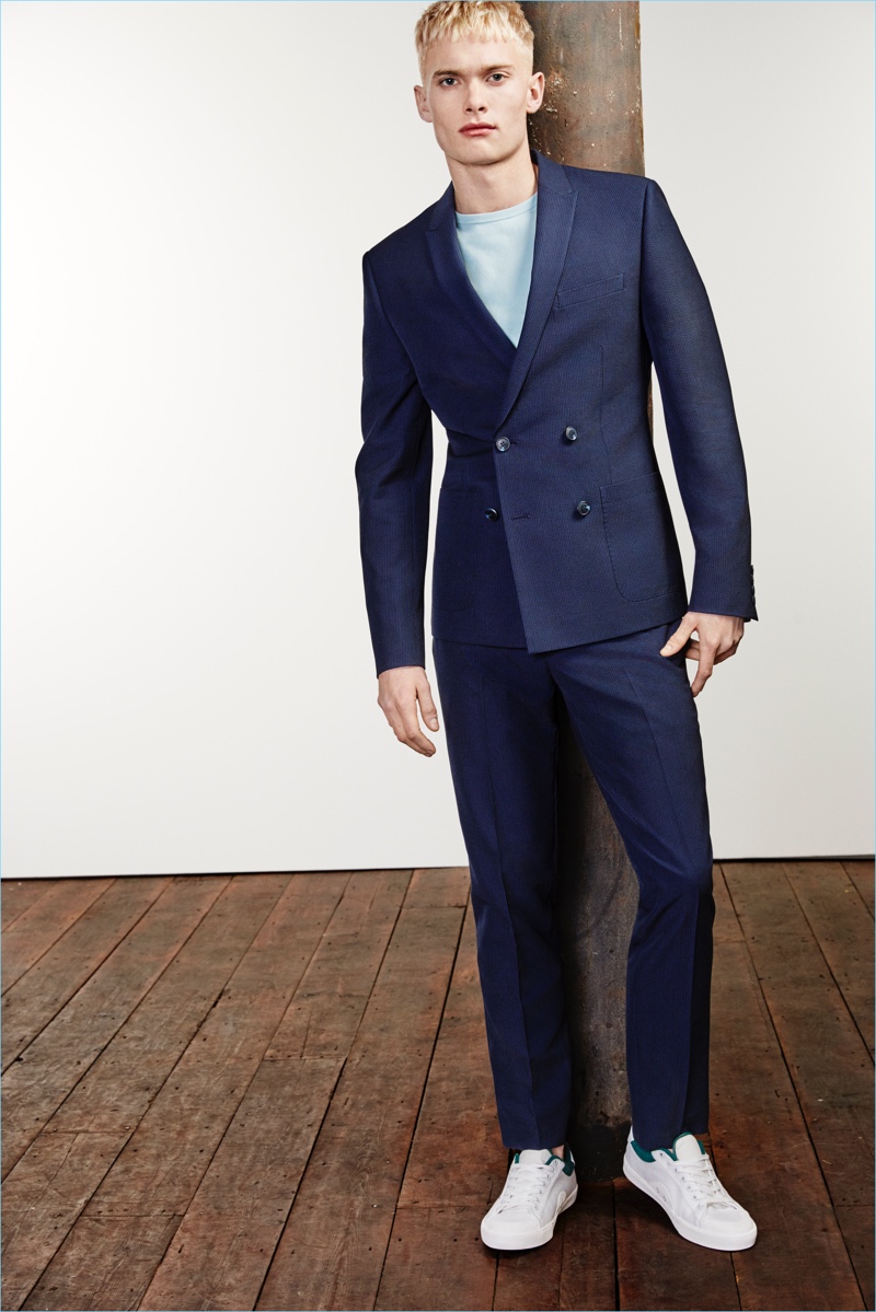 A t-shirt and sneakers contributes to a casual suiting look, which features a navy River Island double-breasted suit jacket $170 and cropped trousers $80.