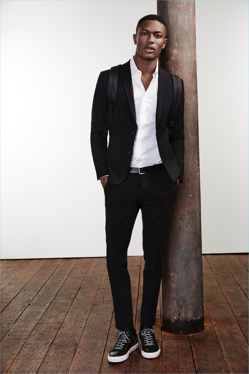 Hamid Onifade is a sleek vision in a River Island black skinny suit jacket $60 and trousers $40.