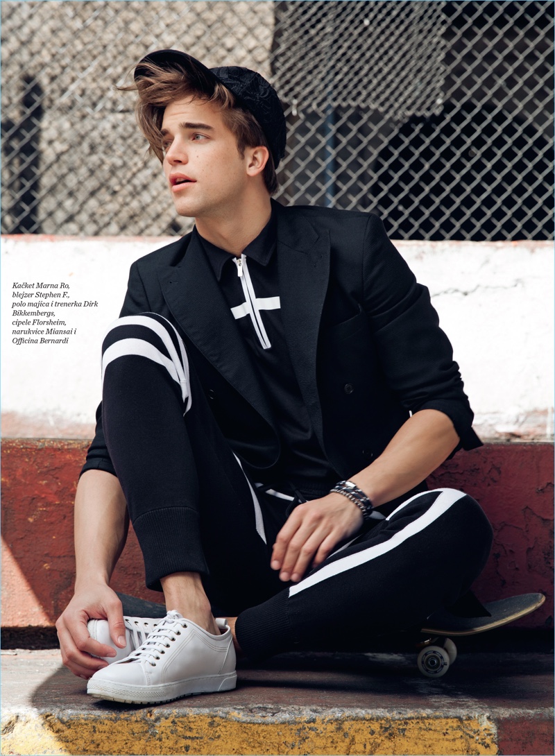 Embracing black and white, River Viiperi wears a Marna Ro cap, Stephen F. blazer, and Florsheim shoes. River also wears a Dirk Bikkembergs polo and joggers.