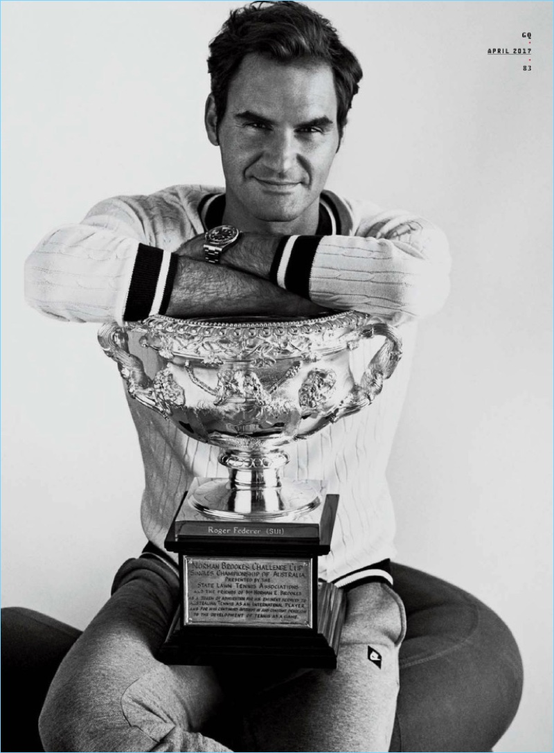 Professional tennis player Roger Federer wears an Armani Exchange sweater with Nike pants, and a Rolex watch.