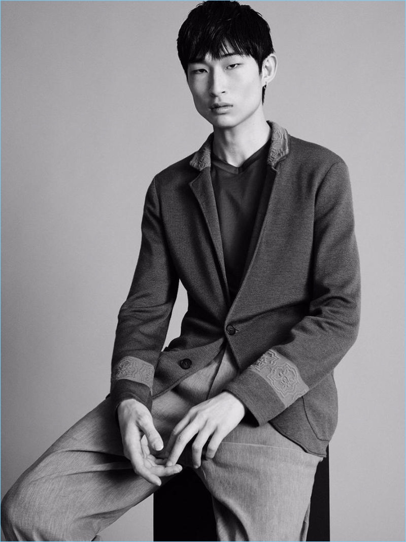 Sitting for a portrait, Sang Woo Kim wears Giorgio Armani.