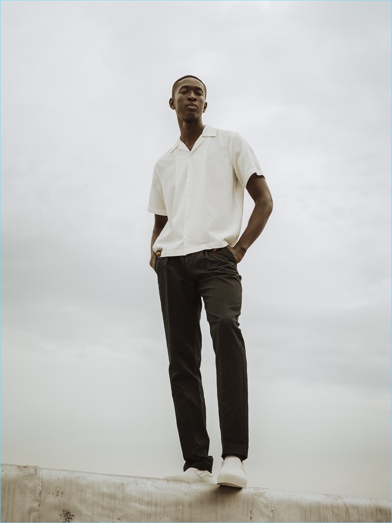 Fallou Diaw wears a Cuban collared short-sleeve shirt with black trousers from Saturdays NYC's pre-fall 2017 collection.
