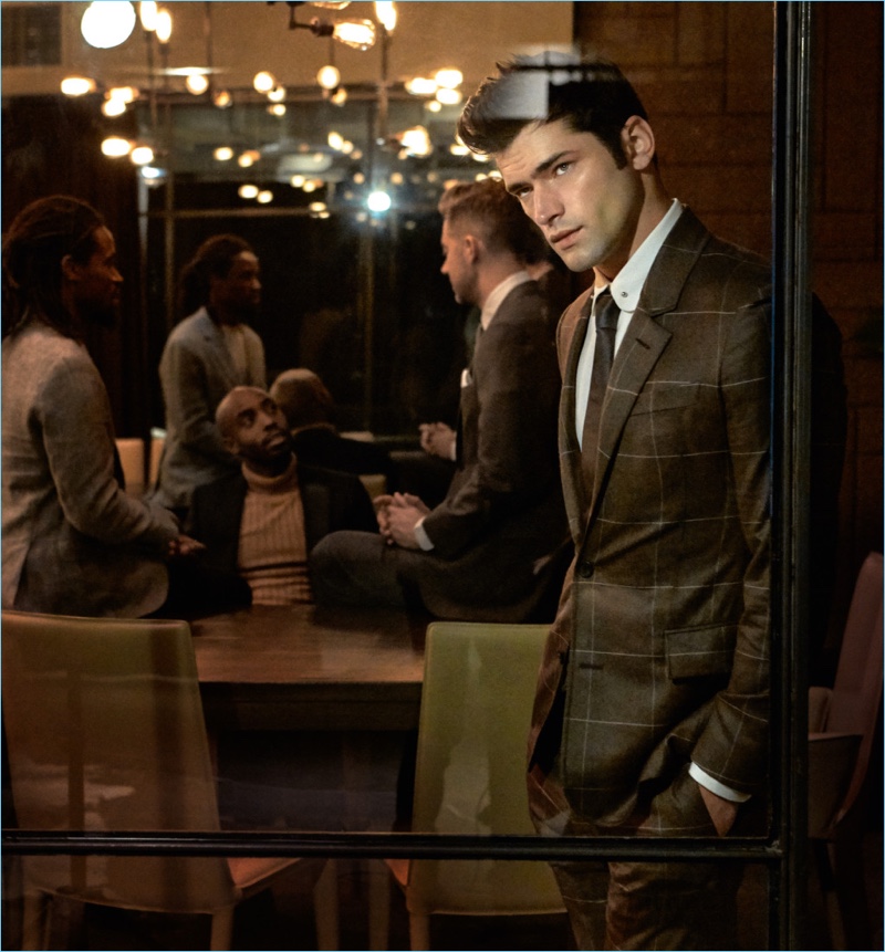 Sean O'Pry dons a Louis Vuitton windowpane print suit and silk shirt with a Hugo Boss tie.