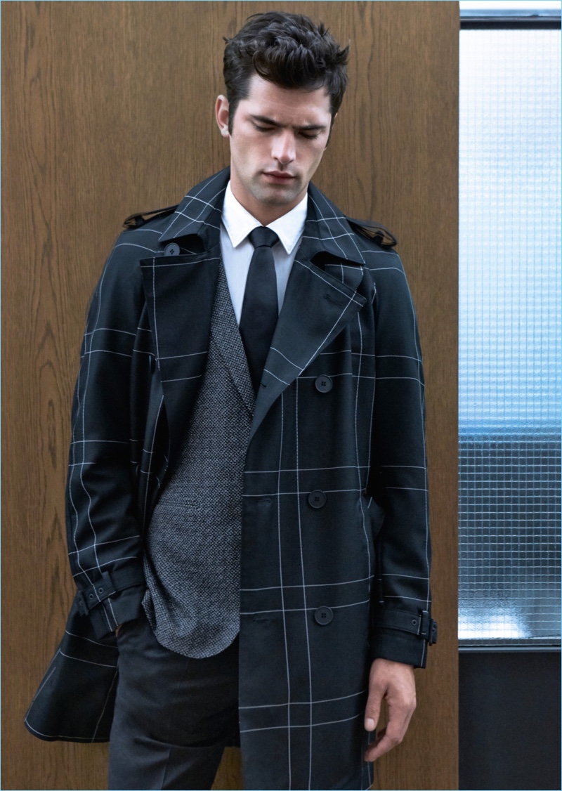 Stealing a moment, Sean O'Pry wears a grid print trench with a wool jacket and trousers by Hugo Boss.