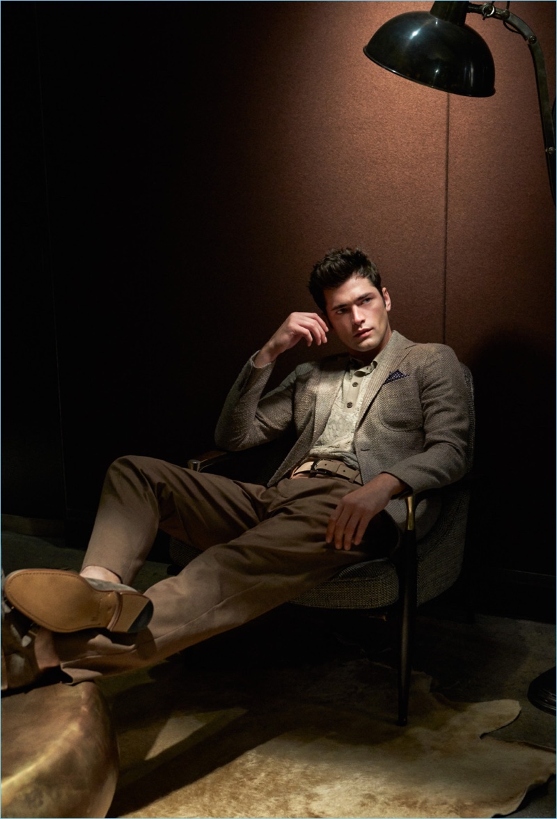 Kicking his Moreschi-clad feet up, Sean O'Pry wears a Louis Vuitton with a Brunello Cucinelli scarf, leather belt, and wool trousers. Sean also wears a Giorgio Armani polo.