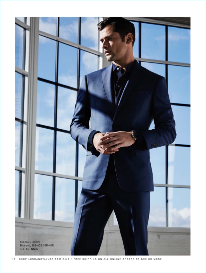 Sean O'Pry sports a navy Michael Kors two-button wool suit $595 from Lord & Taylor.