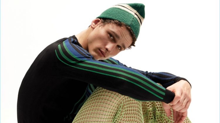 Simon Nessman sports a Balmain sweater with Acne Studios shorts and vintage Vans sneakers.