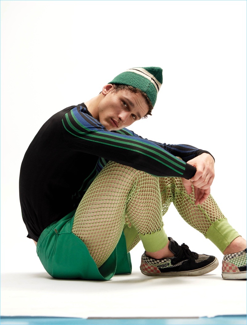 Simon Nessman sports a Balmain sweater with Acne Studios shorts and vintage Vans sneakers.