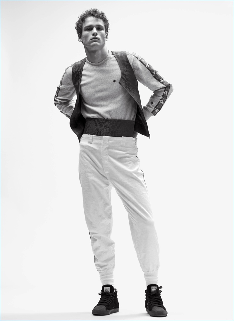 Standing tall, SImon Nessman sports a Champion sweatshirt with a Balenciaga vest and cummerbund. 