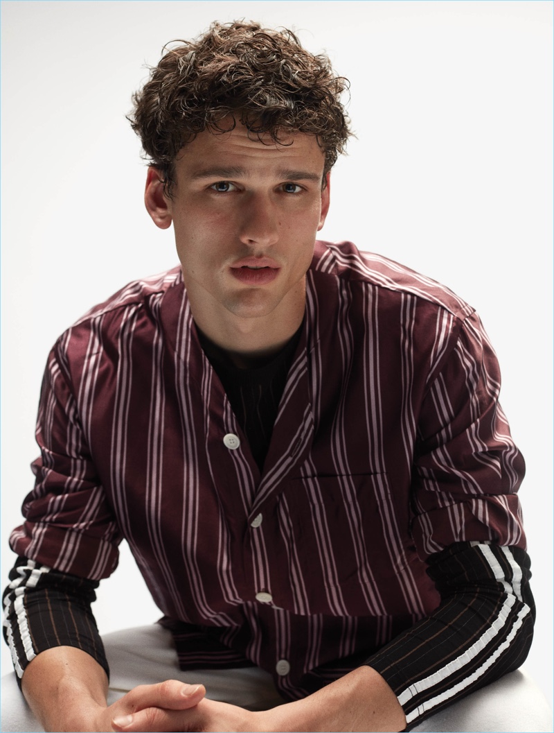 Front and center, Simon Nessman wears a Burberry striped shirt with a Wales Bonner tee.
