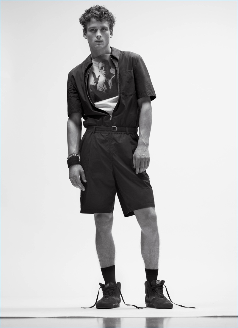 Canadian model SImon Nessman wears a Hermes jumpsuit with a Raf Simons top.