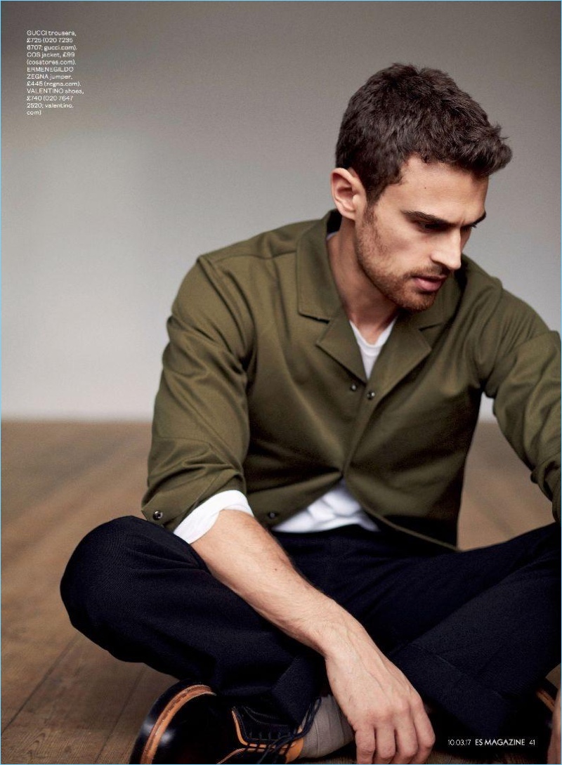 Starring in a photo shoot for ES magazine, Theo James wears a COS jacket, Ermenegildo Zegna sweater, Gucci trousers, and Valentino shoes.