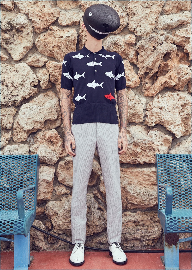 Simon Kotyk wears a Thom Browne shark mask $2,450, shark intarsia polo $1,090, classic backstrap trousers $1,050, and contrast longwing leather brogues $1,250.