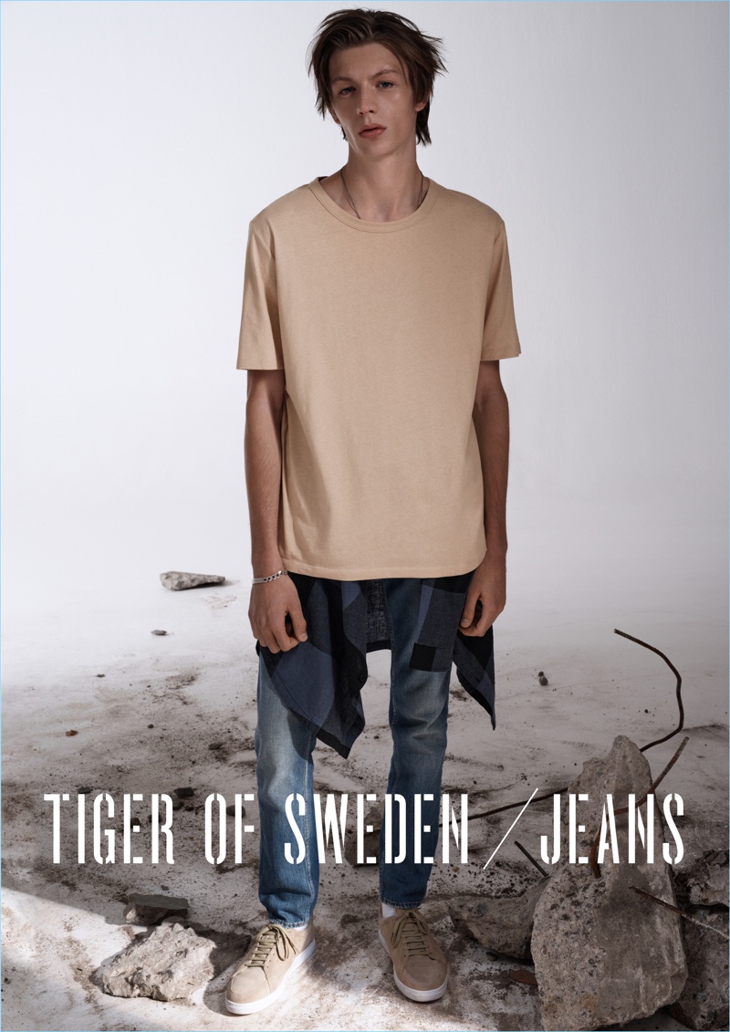 Going casual, Finnlay Davis wears a beige Tiger of Sweden Jeans Biggie t-shirt $90 with blue slim jeans $270.