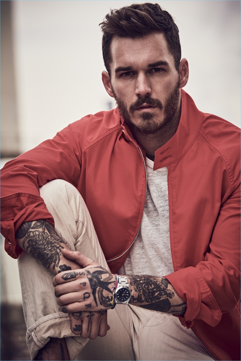 David Alexander Flinn wears a red Harrington jacket $328 from Todd Snyder's Champion collaboration. The tattooed model also sports a pocket tee $78 and selvedge birch rinse jeans $198.