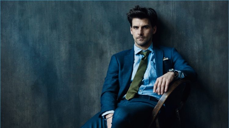 Wearing a navy suit, Johannes Huebl stars in Todd Snyder's Well Suited campaign.