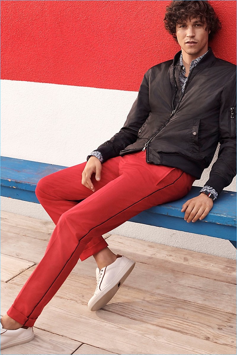 Straight and Narrow: Miles McMillan dons a Tommy Hilfiger nylon bomber jacket $250, New York fit cotton and linen shirt $99.50, and white leather court shoes $139.50.