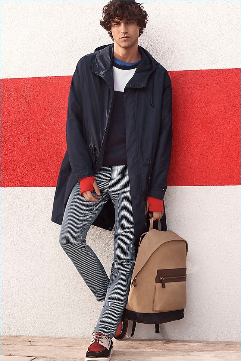 Shape Shift: Miles McMillan embraces nautical style in a Tommy Hilfiger modern parka $350 and color block sweater $119.50. Miles also wears a cotton stretch tee $35.50, pinstripe slim straight chinos $139.50, a washed canvas backpack $129.50, and color block suede deck shoes $129.50.