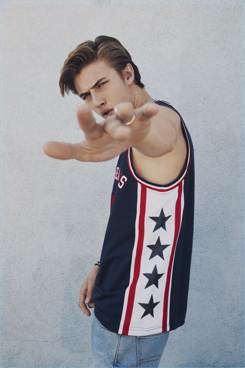 Lucky Blue Smith sports a Tommy Jeans basketball tank $99.50 and denim carpenter shorts $119.50.