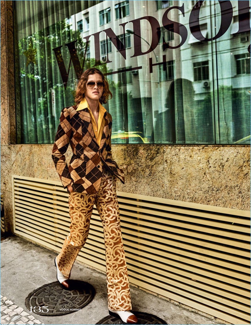 Ariel Rosa embraces a retro look in a patchwork jacket and silk trousers by Roberto Cavalli. The model also sports a vintage shirt and Salvatore Ferragamo shoes.