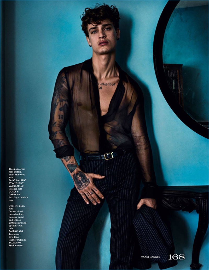 Jonathan Bellini sports a sheer silk chiffon shirt and pinstripe trousers by Saint Laurent.