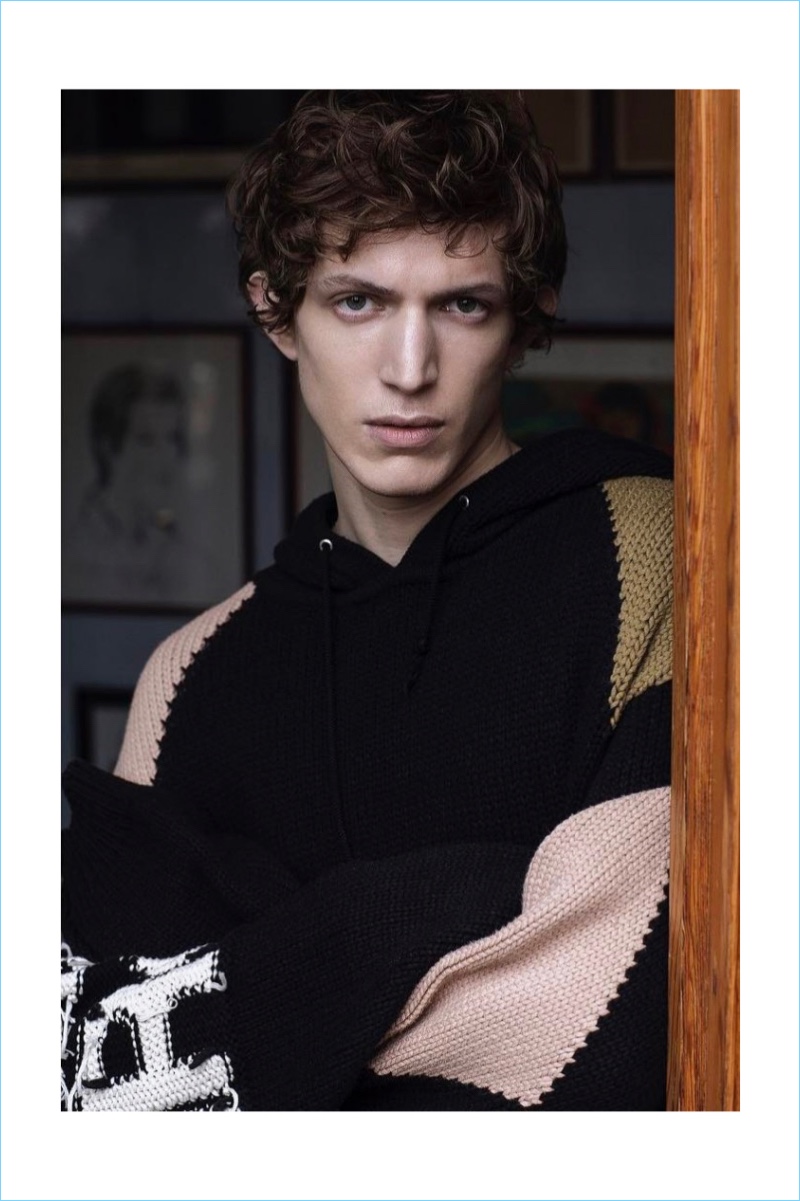 Xavier Buestel dons a hooded knit sweater by Stella McCartney.