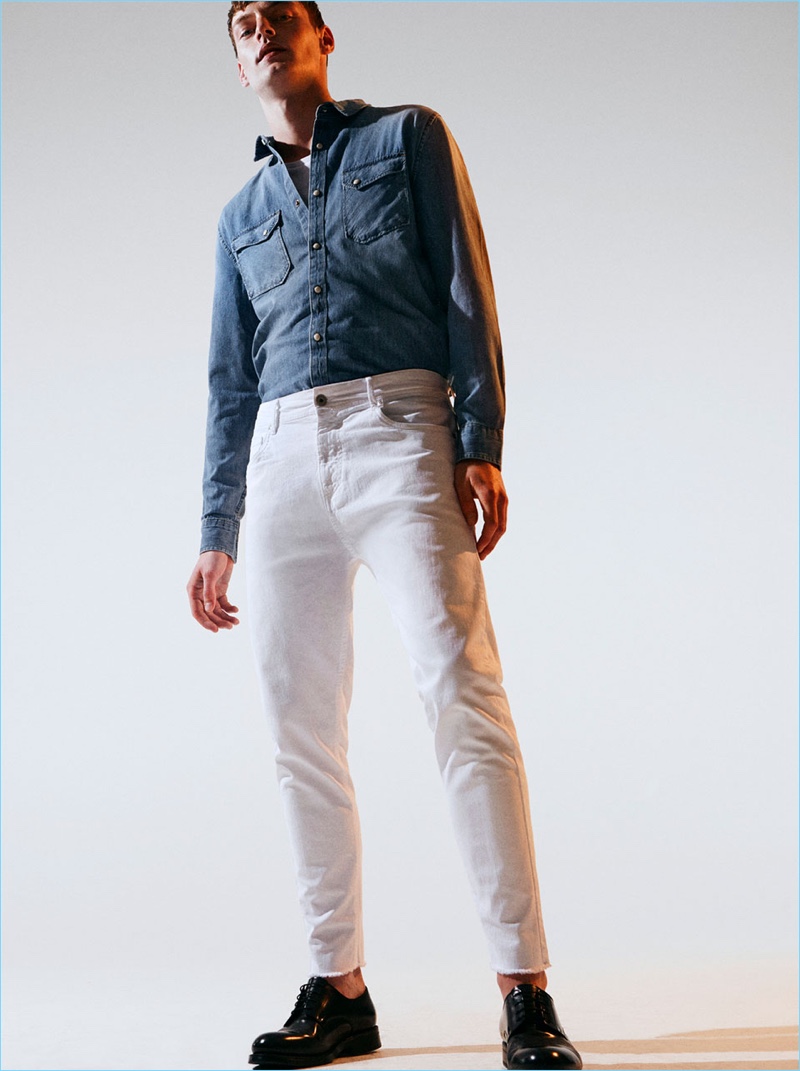 Offering a fresh spin on double denim, Roberto Sipos sports white jeans with a denim shirt from Zara Man.