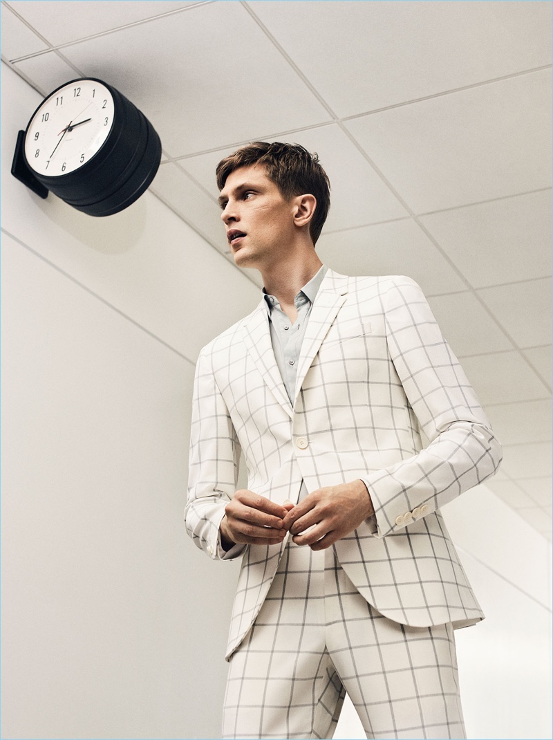 Mathias Lauridsen dons a windowpane print suit by Zara Man.