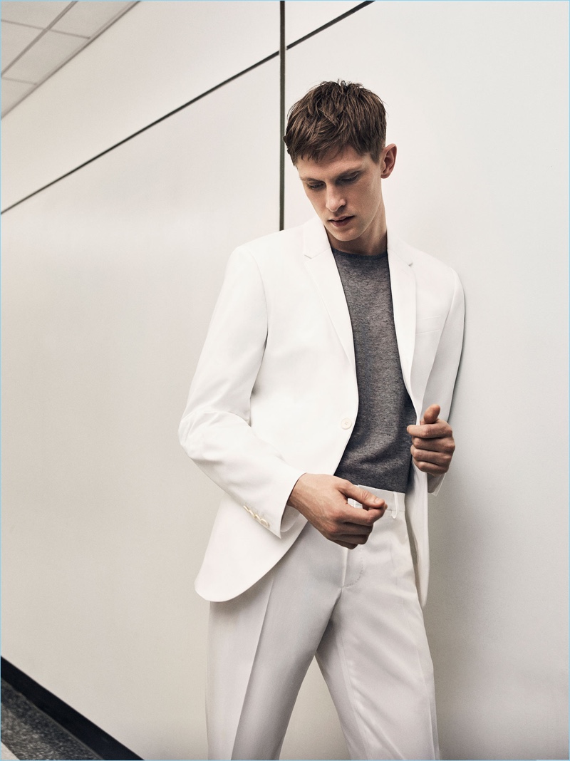 Danish model Mathias Lauridsen is a sleek vision in a summer white suit from Zara Man.