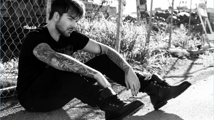 Adam Lambert wears a Cult of Individuality t-shirt and jeans with COS boots.