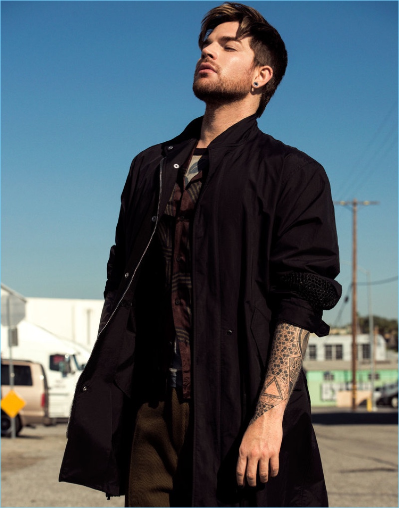Starring in a Flaunt photo shoot, Adam Lambert sports a 3.1 Phillip Lim coat with a Dries Van Noten shirt and t-shirt. Lambert also wears Acne Studios pants.