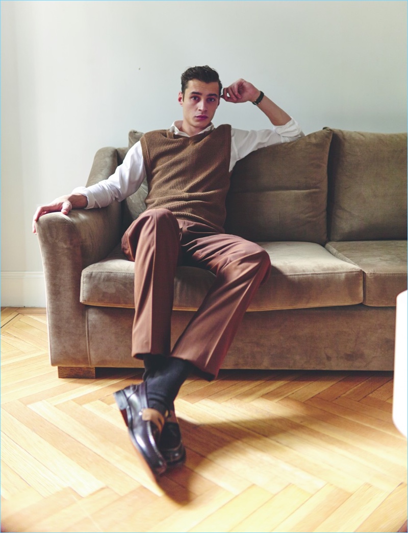 Relaxing, Adrien Sahores wears a sweater vest, trousers, and shoes by Ermenegildo Zegna. Adrien's look is complete with an Emidio Tucci shirt and Blancpain watch.