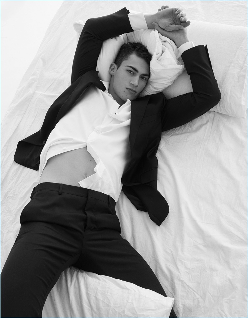 Laying in bed, Alessio Pozzi wears all Prada.