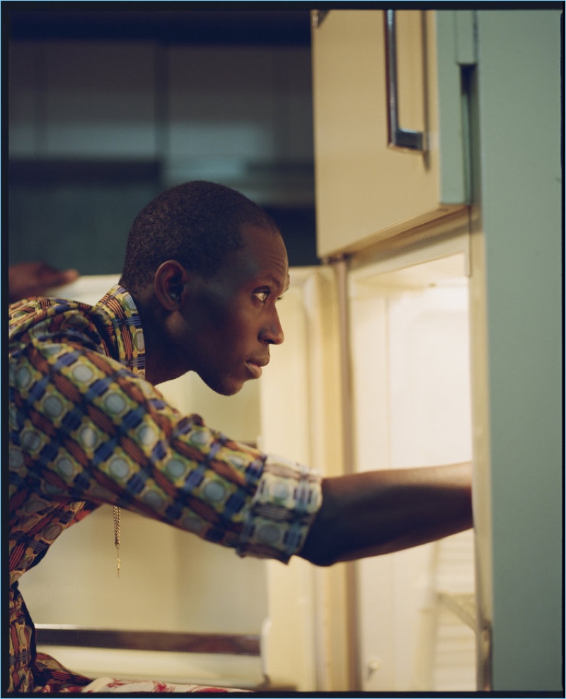 Peering into the fridge, Armando Cabral rocks an Etro shirt.