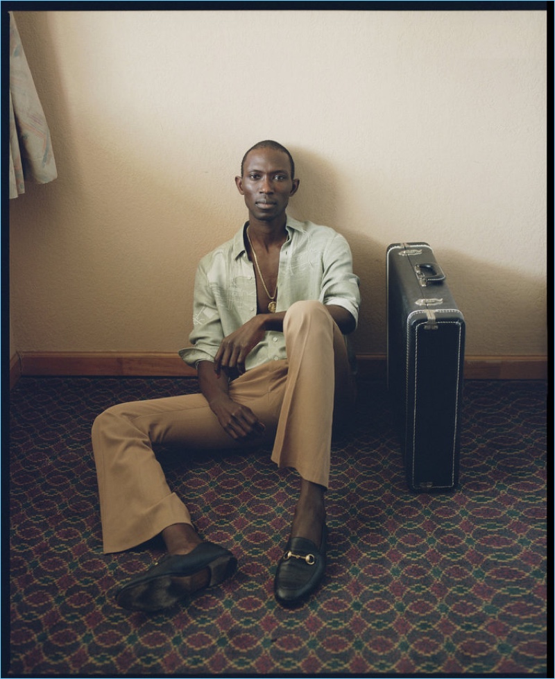 Posing for a relaxed image, Armando Cabral dons a Loewe shirt with Jeffrey Rudes trousers. Armando also sports a Dior Homme belt and Gucci shoes.