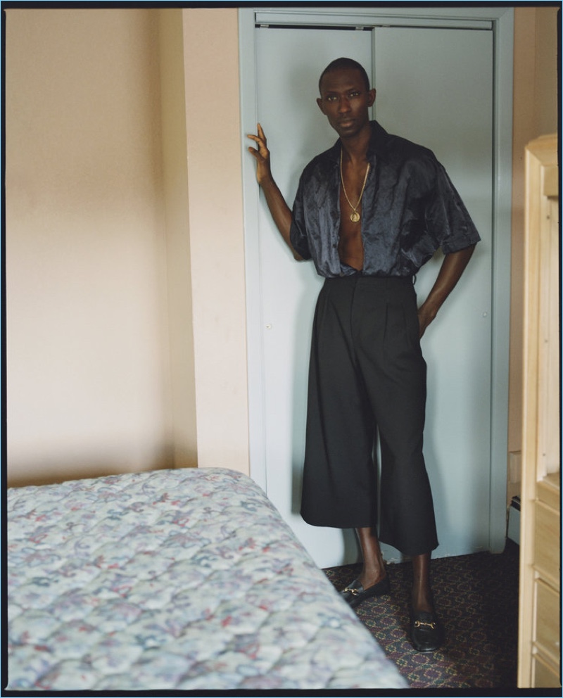 Appearing in a Flaunt editorial, Armando Cabral wears a Lanvin shirt, J.W. Anderson wide leg trousers, and Gucci loafers.
