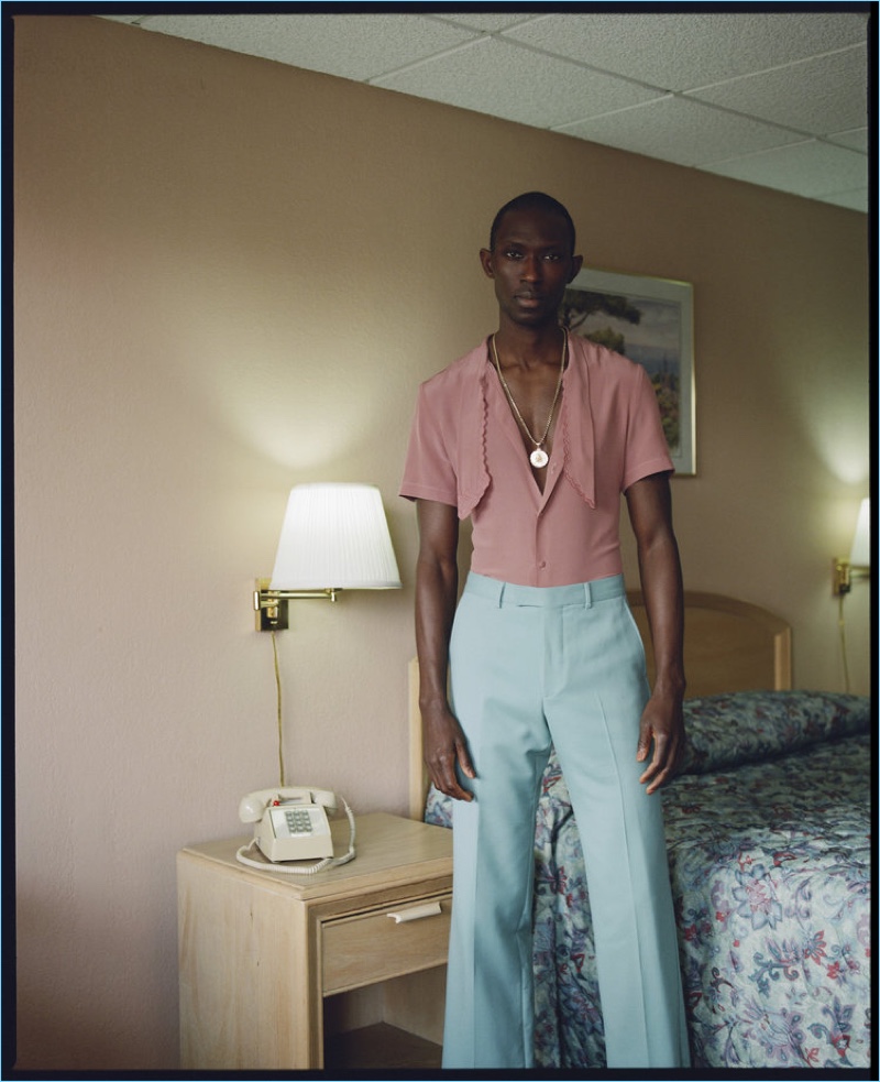 Checking into a motel, Armando Cabral wears a Gucci look.
