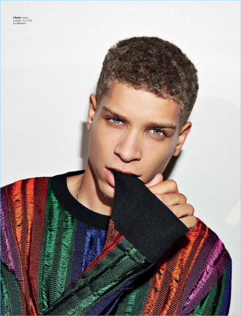 Chuck Achike wears a colorful Balmain sweater.