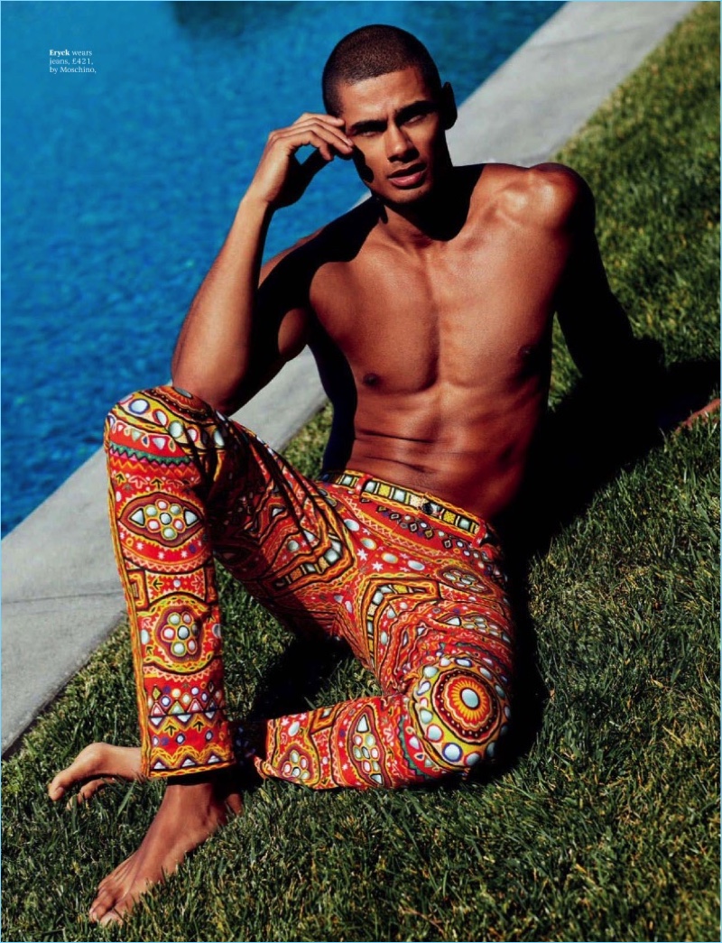 Relaxing poolside, Eryck Laframboise wears colorful Moschino jeans.