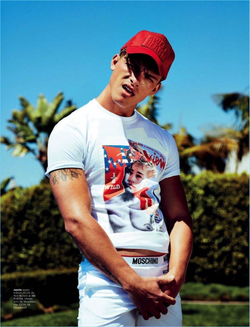 Posing for a cheeky picture, Austin Victoria wears a Neil Barrett t-shirt with Moschino shorts and a Dsquared2 cap.