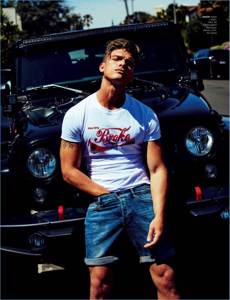 Model Austin Victoria rocks a Christopher Shannon t-shirt with GUESS denim shorts.