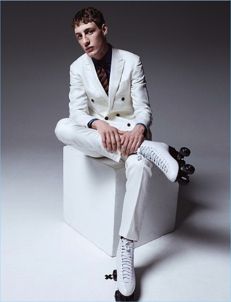 Donning a sleek white Canali suit, Aubrey also wears an Ermenegildo Zegna Couture shirt and Ermenegildo Zegna tie.